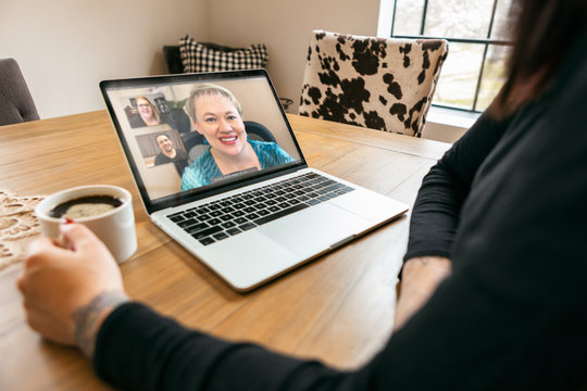 Staying Home: Woman With Coffee In Virtual Work Meeting