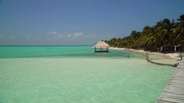 Onok Island Balabac, Philippines. The island of white sand on a large atoll. Tropical island with palm trees. Seascape with a paradise island.