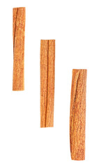 Three cinnamon sticks isolated on a white background, top view.