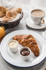 French breakfast table with croissant and coffee