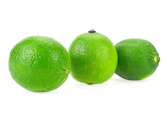 Three limes isolated on a white background, close up.