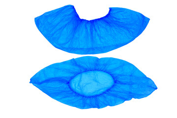 An isolated pair, two medical, blue, disposable Shoe covers on a white background. Shoe covers are located under each other. Top and side view.