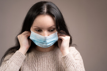 Girl wearing a medical mask, the concept of preventing the spread of coronavirus.