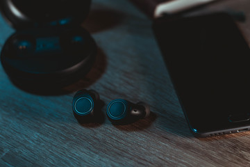Wireless earphones photoshoot od wooden table