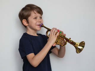 little boy plays the trumpet
