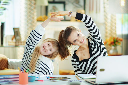 Mom And Child In Modern Living Room In Sunny Day Stretching