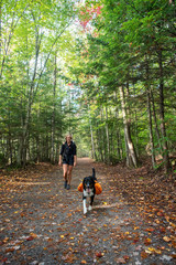 girl and dog hiking in the woods