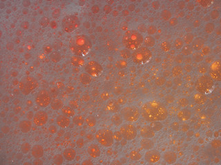 Abstract, decorative background, water drops on a multi-colored, blurred background of a warm tone, macro photography. Screen saver, artistic texture.