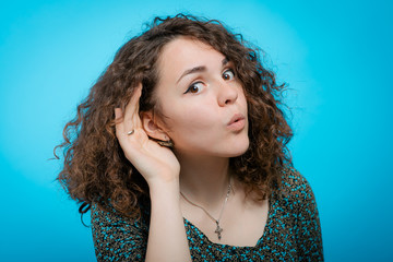 Overhears a woman, tries to listen.
