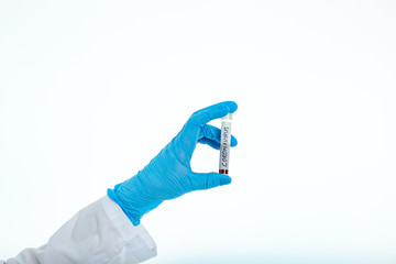 A nurse s hand in a glove holds a test tube with the inscription Coronavirus, with a positive blood test for a new rapidly spreading coronavirus, close-up, shallow depth of field, selective focus.