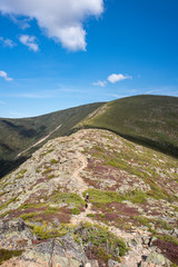 mountain hiking trail with blue sky and clouds
