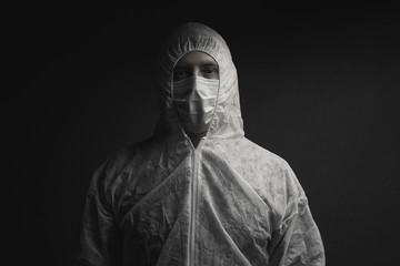 Fototapeta na wymiar dramatic portrait of physician in protective suit and protective mask