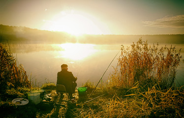Amateur angler is fishing on autumn in the lake © photoidea