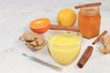 Golden turmeric latte with ginger root, cinnamon sticks, turmeric, spices for Ayurvedic medicine. The concept of alternative medicine, a means to increase immunity in a pandemic, coronovirus