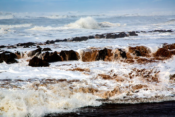 Beautiful powerful waves with white foam beating on a rocky shore in the Atlantic Ocean, Casablanca, Morocco