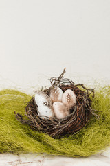 Easter eggs in a bird's nest on a marble background
