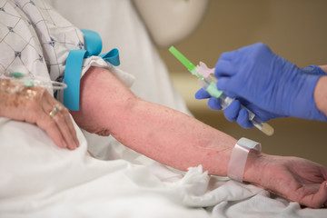 Nurse wearing PPE Personal Protective Equipment getting ready to treat patient in hospital