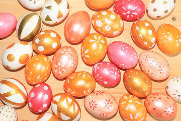 Decorated golden easter eggs on trendy wooden background. Minimal holiday concept. Happy Easter background, greeting card, banner for the screen.