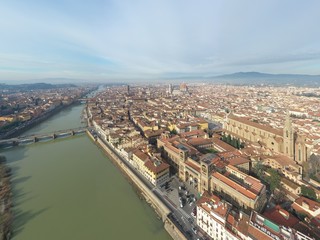 Fototapeta premium Aerial panorama of Florence at sunrise, Firenze, Tuscany, Italy, cathedral, river, drone pint view, mountains is on background