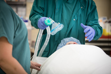 Oxygen mask ventilator is put on a patient prior to surgery anesthesia