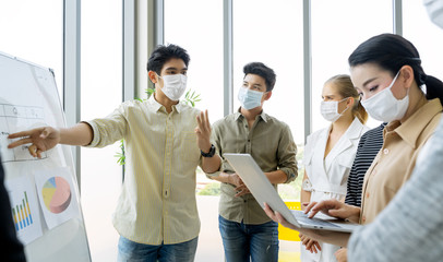 Group of asian business people meeting and working in office and wear mask for protect  prevent...