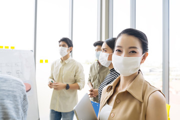 Group of asian business people meeting and working in office and wear mask for protect  prevent infection corona virus covid 19. - Powered by Adobe
