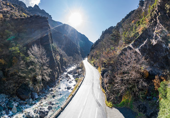 The mountain river along the Road, Aerial panoramic drone view of a scenic highway by the beautiful Landscape covered in clouds and fog, bridge and viaduct, The mountain river along the road,