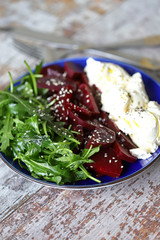 Healthy salad with arugula, beets and mascarpone cheese. Keto diet. Healthly food.