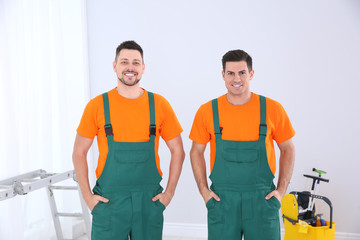 Team of professional janitors in uniform indoors. Cleaning service