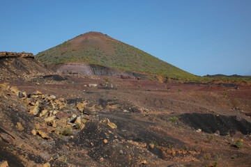 Walk in the arid volcanic landscape with scarce vegetation connecting Santiago del Teide to Arguayo, a popular difficult trail in search of the flowering almond trees, Tenerife, Canary Islands, Spain