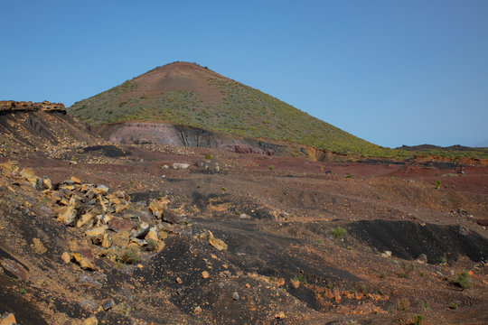 Walk in the arid volcanic landscape with scarce vegetation connecting Santiago del Teide to Arguayo, a popular difficult trail in search of the flowering almond trees, Tenerife, Canary Islands, Spain