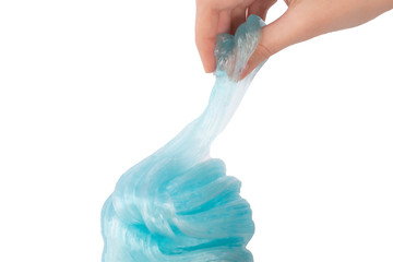 Hand making a rose from a blue slime on a white background.Selective soft focus.Concept of...