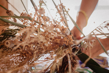 Dried flowers and girl's hands