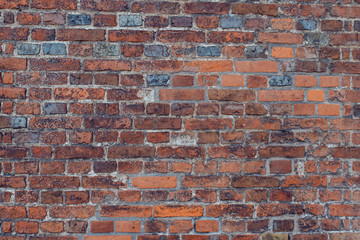 Weathered stained old brick wall background