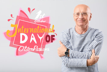 Portrait of elderly man on grey background. International day of older persons