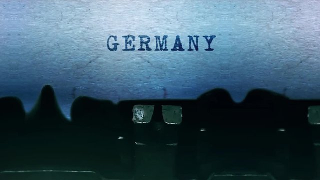 GERMANY Word closeup Being Typing and Centered on a Sheet of paper on old vintage Typewriter mechanical 4k Footage Background Animation.