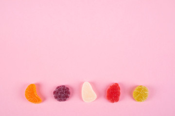 colorful candies jelly on pink background