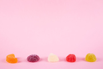 Obraz na płótnie Canvas colorful candies jelly on pink background