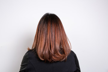 Close up of smooth red-haired woman shot from behind isolated on wite background