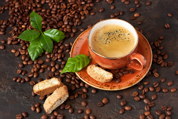 Cup of coffee and tasty cookies cantuccini on  dark  background