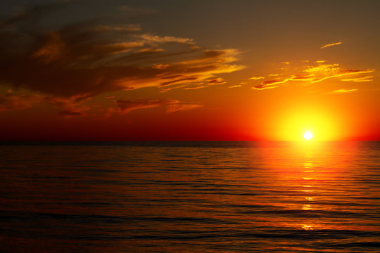 Beautiful sunset over the sea with clouds © Екатерина Переславце