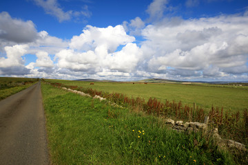 Orkney (Scotland), UK - August 09, 2018: A typical road in the Orkney islands, Orkney, Scotland, Highlands, United Kingdom