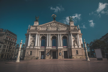 Fototapeta premium Beautiful opera building in Lviv, Ukraine on a hot summer day. Some clouds seen on blue skies.