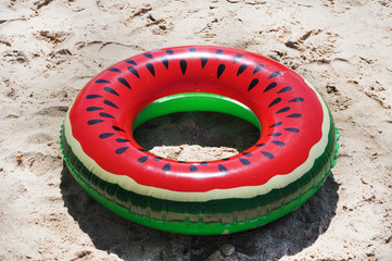 Multi-colored inflatable swimming ring on the beach on a sunny day. Black Sea beach of the...