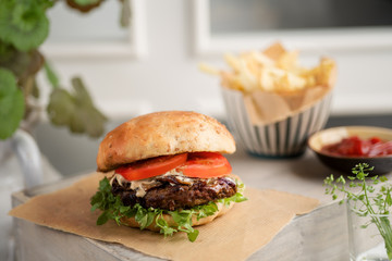 Gourmet Burger on a table next to a window