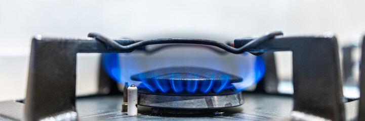Modern kitchen stove cook with blue flames burning