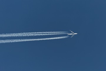 Plane at cruising altitude against blue sky