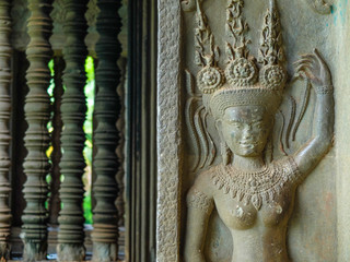 Dancing apsara and columns, an old ornament on the ancient wall, Angkor Wat, Cambodia