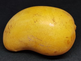 Ripe mango ready to eat on a black background