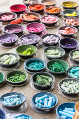 A rainbow of multi-colored chalks in bowls at a chalk art festival in Denver, Colorado